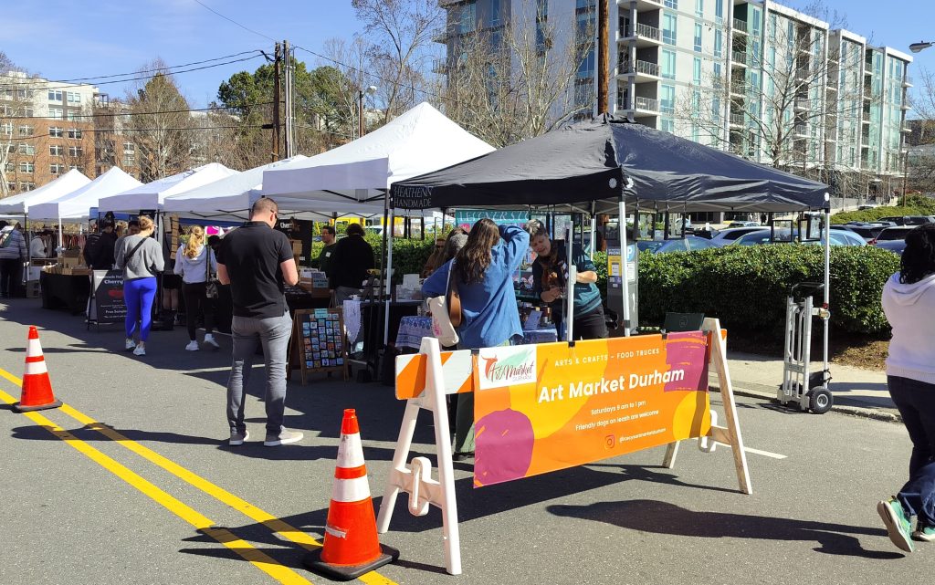 craft market vendors under canopies in the street