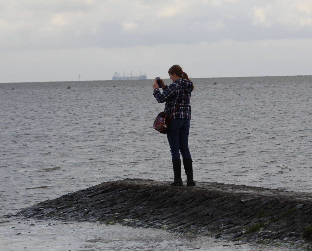 Julia taking pictures at the North Sea beach