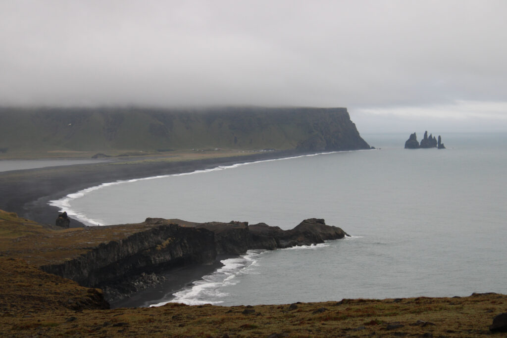 View from Dyrhólaey of the Reynisfjara Beach and basalt formations