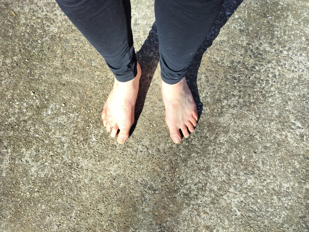 bare feet standing on concrete surface