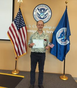 Jurgen with naturalization certificate